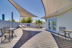 A wooden deck with outdoor seating and a covered area. - Indialantic Oasis - 2 Mi to Canova Beach Park (Indialantic)