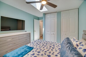 A bedroom with a bed, a ceiling fan, a TV mounted on the wall, and a wardrobe. - Indialantic Oasis - 2 Mi to Canova Beach Park (Indialantic)