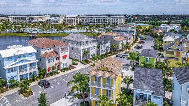 A coastal residential area with colorful houses, a marina, and a hotel in the background. - 3 Mi to Disney: Home w/ Hot Tub in Margaritaville! (Kissimmee)