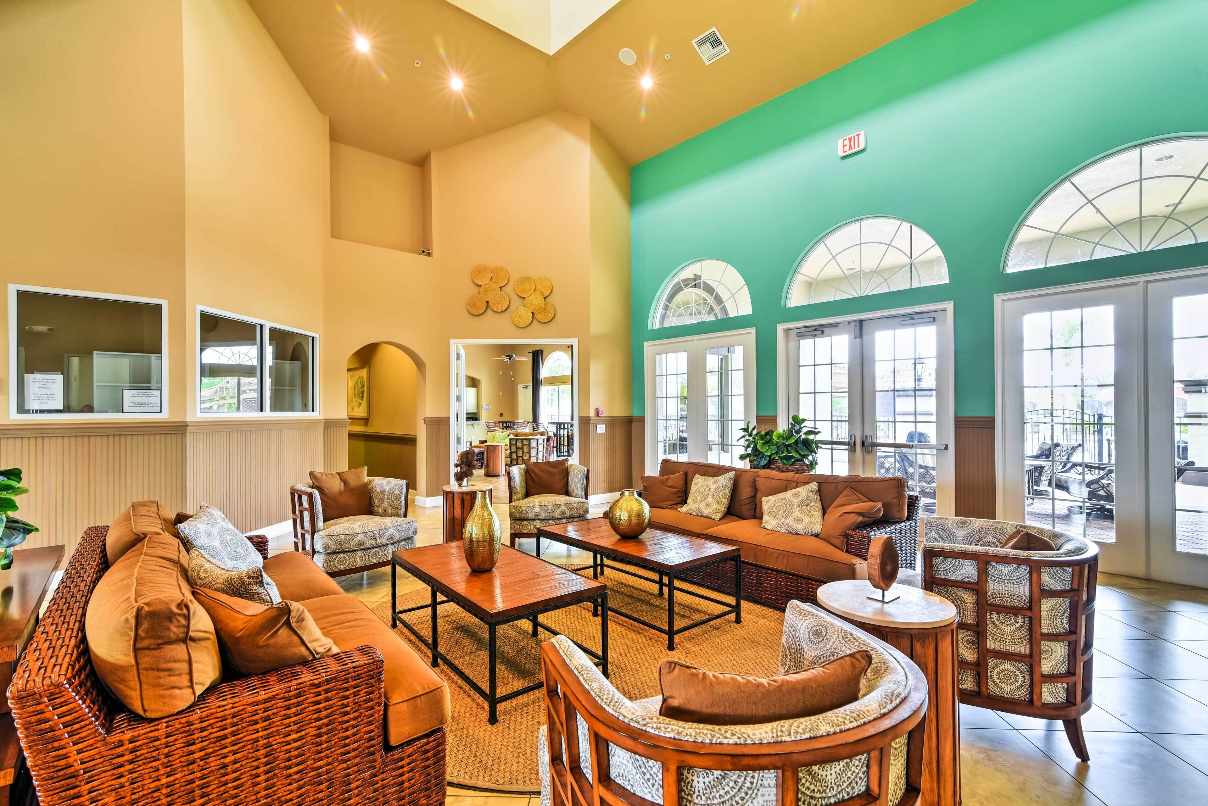 A spacious lobby with wicker furniture, a coffee table, and a large mirror.