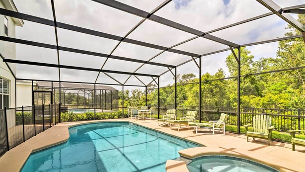 A swimming pool with a hot tub, surrounded by outdoor seating and a covered area. - Home w/ Private Pool & Spa: 8 Mi to Disney (Kissimmee)