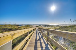 A wooden boardwalk leading to a beach with a clear sky and sun shining. - St. Augustine Condo Near Flagler College & Beach! (St. Augustine)