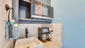 A kitchen with a microwave, coffee maker, and sink. - Beachfront Studio w/ Community Indoor Pool! (Daytona Beach)