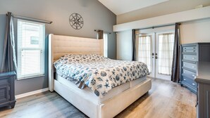 A bedroom with a large bed, a ceiling fan, and a wardrobe. - Private Yard & Pool: Stunning Cape Coral Getaway! (Cape Coral)