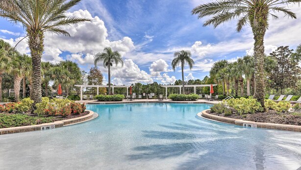 A swimming pool with a 6-inch depth marker, surrounded by palm trees and lounge chairs. - Outdoor Oasis w/ Pool: Davenport Resort Escape! (Davenport)