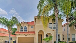 A two-story house with a beige facade, red-tiled roof, and a garage. - Outdoor Oasis w/ Pool: Davenport Resort Escape! (Davenport)