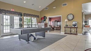 A pool table in a well-lit room with a clock and a sign indicating an exit. - Disney Villa w/ Game Room & Pool - 10 Mi to Parks! (Clermont)