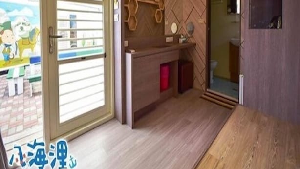 A modern kitchen with a wooden countertop, a built-in oven, and a large window. - Bahile (Liuqiu)
