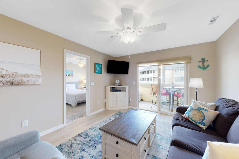 The Palms condo with a furnished balcony, pond view, washer/dryer, & pool
