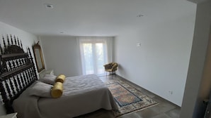 A bedroom with a bed, a chair, a dresser, a mirror, and a window with curtains. - Cozy Nest w/private garden next to vineyards and great wineries (Cambados)