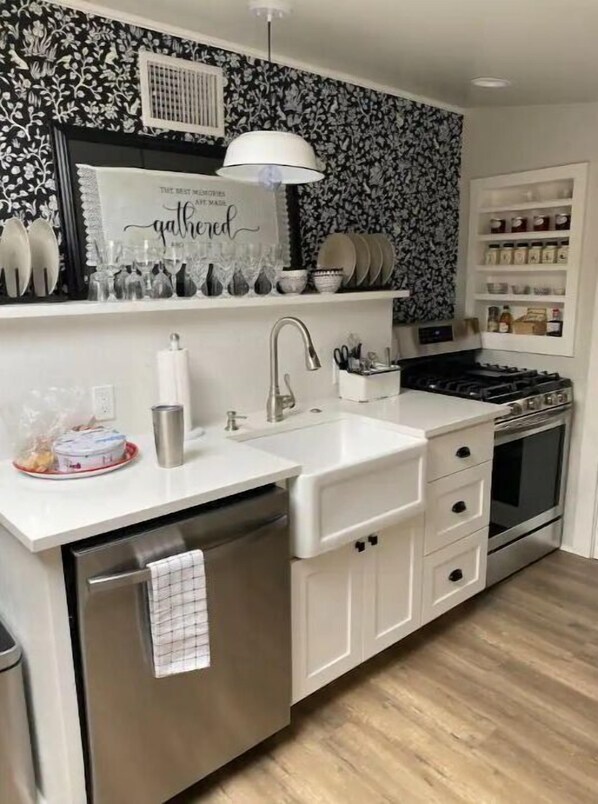 Enjoy cooking in this well-equipped kitchen with a central island, sink, oven, and gas stove.