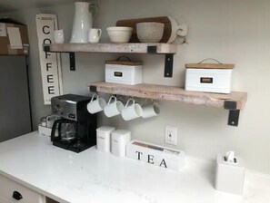 Enjoy a warm cup of coffee or tea in our kitchen, where a selection of brewing essentials awaits.