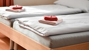 Two single beds with white linens and a wooden headboard. - Apartment Heidi by Interhome (Saas-Fee)