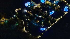 An aerial view of a resort with multiple swimming pools and well-lit pathways. - Villa Yellow.
Inviting you to discover it with every moment
Villa Paradise Hotel (Naxos)