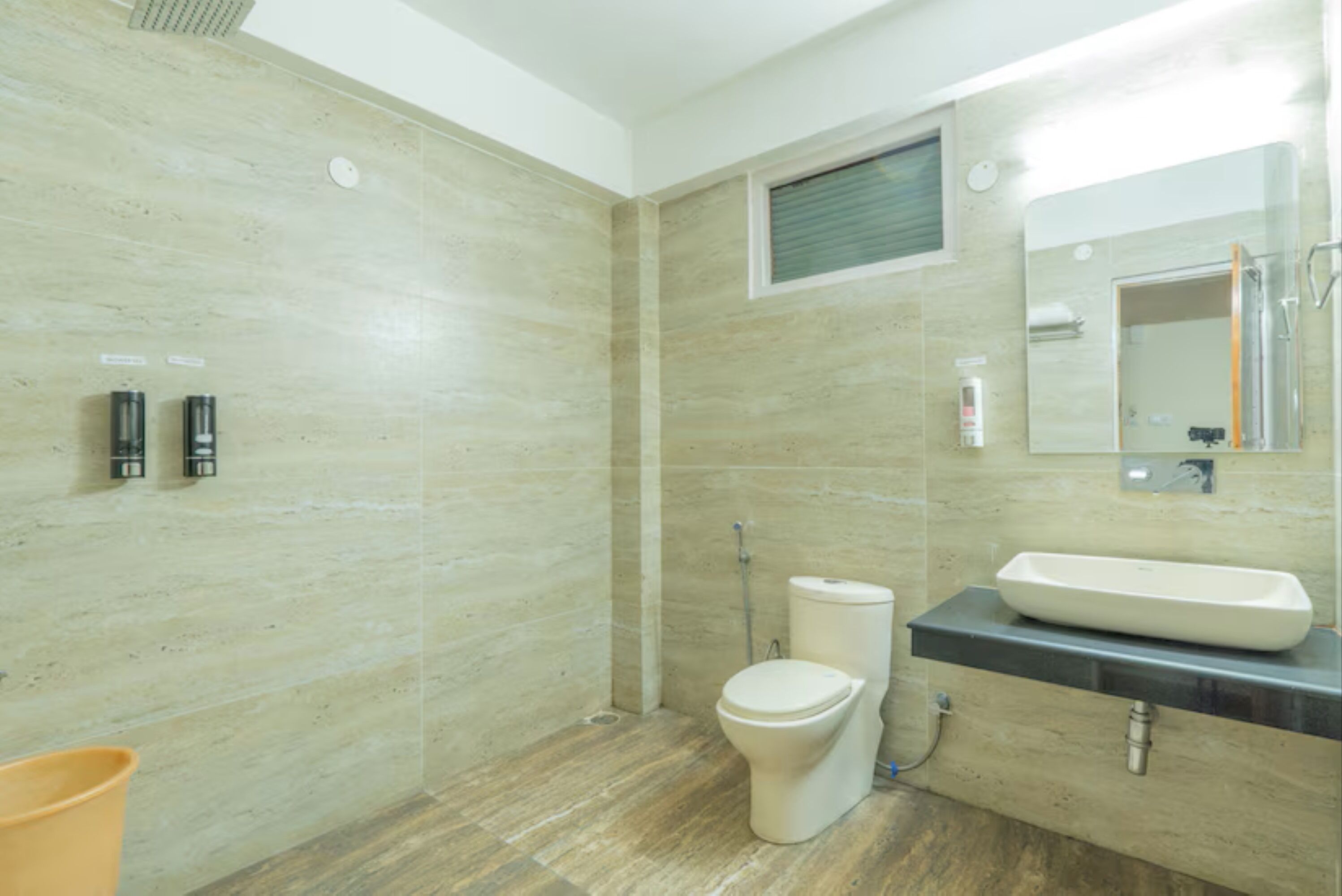 A modern bathroom with a toilet, bidet, and sink.