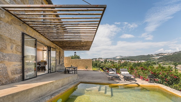 A pool area with a pergola, outdoor seating, and a view of the surrounding landscape. - Lemon House - Valpendre (Valpedre)