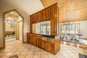 Enjoy meals in the kitchen with a large island and dining area overlooking a scenic view.