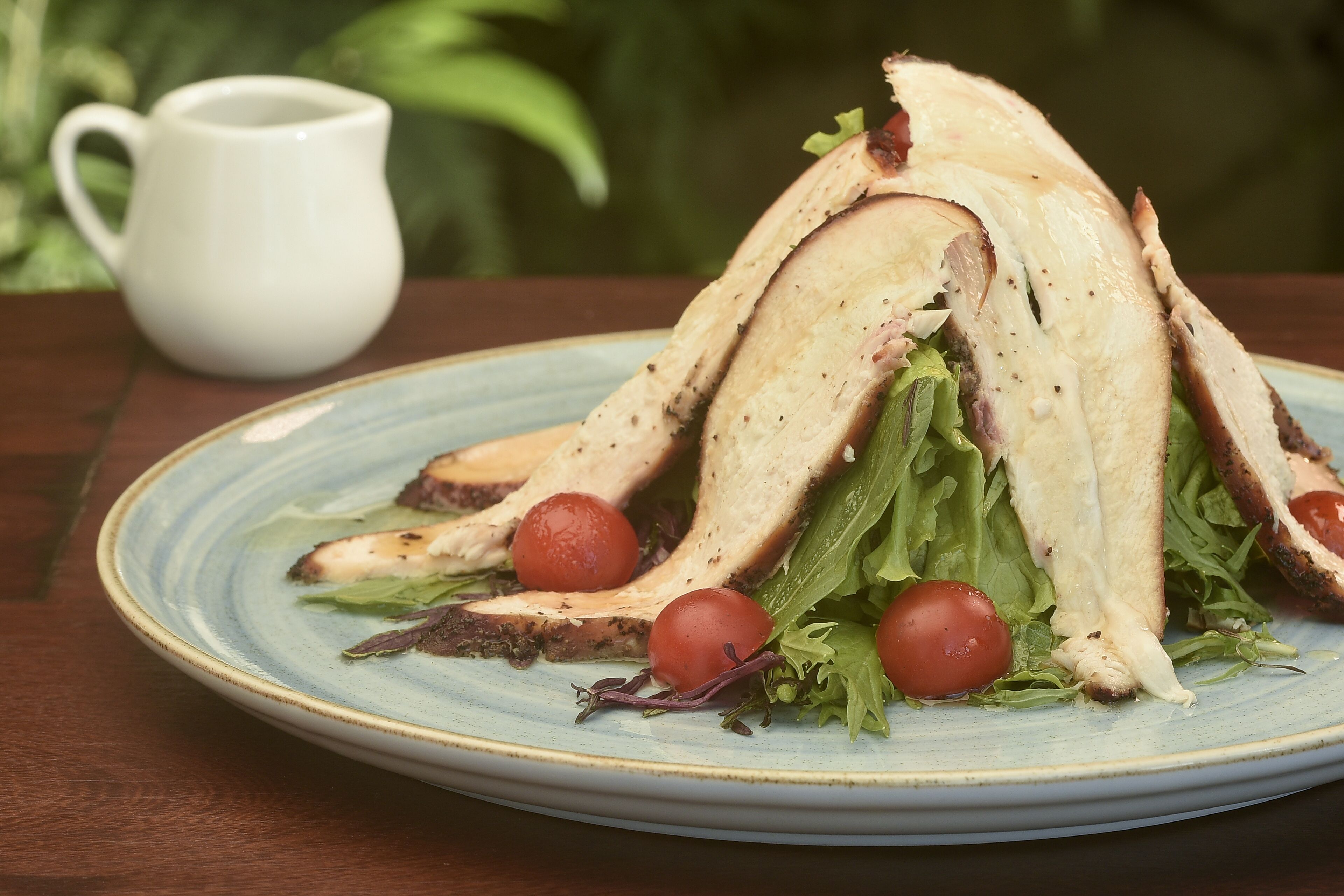 A plate with a sandwich and cherry tomatoes.