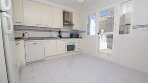 A kitchen with white cabinets, a dishwasher, an oven, and a microwave. - Marina de la Duquesa 544 (Manilva)