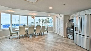 A spacious kitchen with a large island, stainless steel appliances, and a view of the ocean. - Beautiful Daytona Beach Shores Condo w/ Hot Tub! (Daytona Beach Shores)