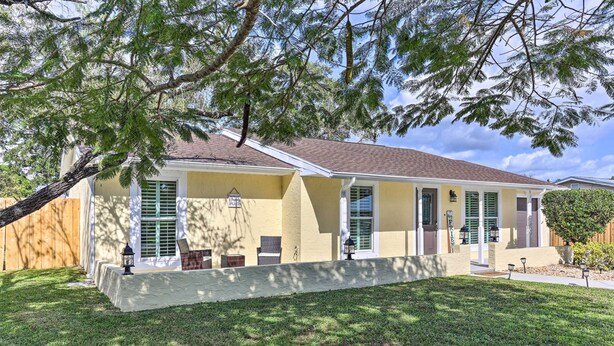 A two-story house with a front porch, a covered entryway, and a well-maintained lawn.