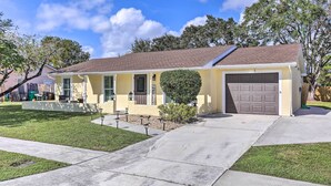 A single-story house with a front garage, a small front yard, and a well-maintained lawn.