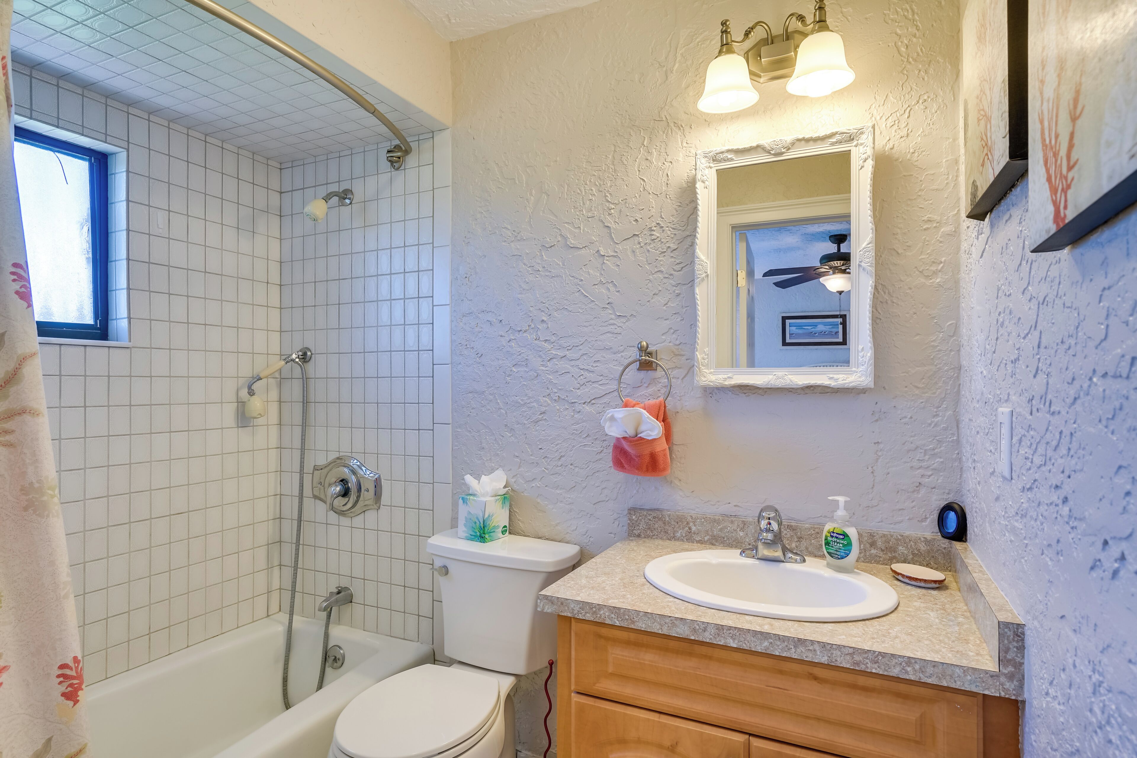A bathroom with a bathtub, toilet, and sink.