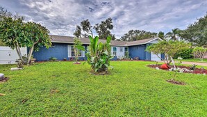 A residential house with a well-maintained lawn, a small tree, and a clear sky. - Convenient Sarasota Studio w/ Lush Backyard! (Sarasota)