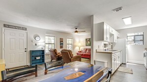 A modern kitchen with white cabinets, a built-in oven, and a window overlooking the living area. - Charming Tallahassee Townhouse ~ 3 Mi to Fsu! (Tallahassee)