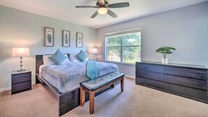 A bedroom with a bed, bedside tables, a bench, a ceiling fan, a window, and a dresser. - Chic Resort Townhome ~ 9 Mi to Disney Parks! (Davenport)