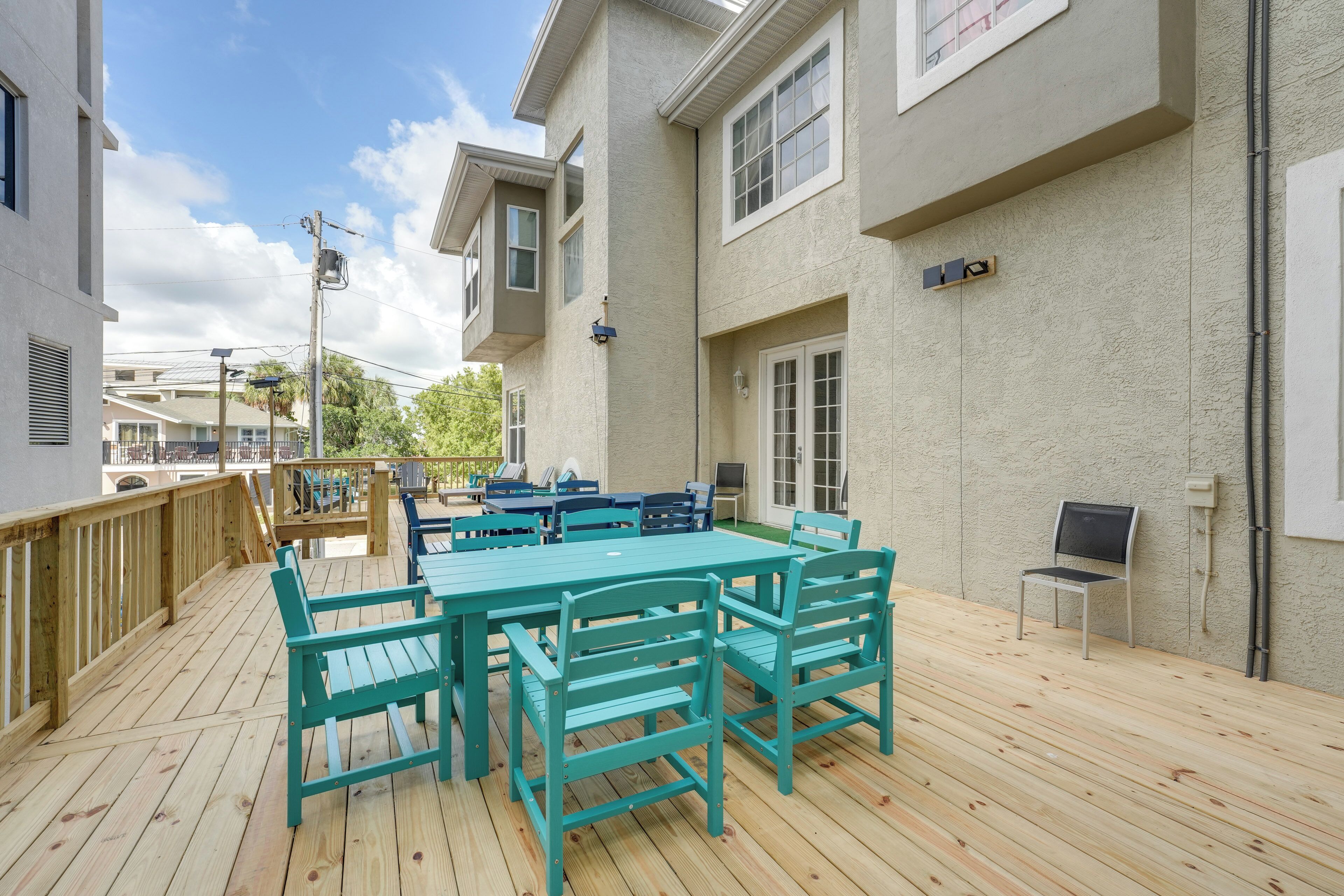 A deck with a table and chairs, a grill, and a TV.