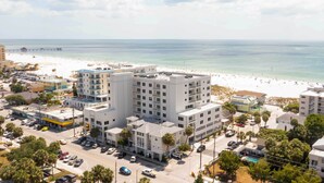 A coastal hotel with multiple floors, a beach view, and a parking area. - Coastal 'sea Side' Townhome - Walk to Beach! (Clearwater Beach)