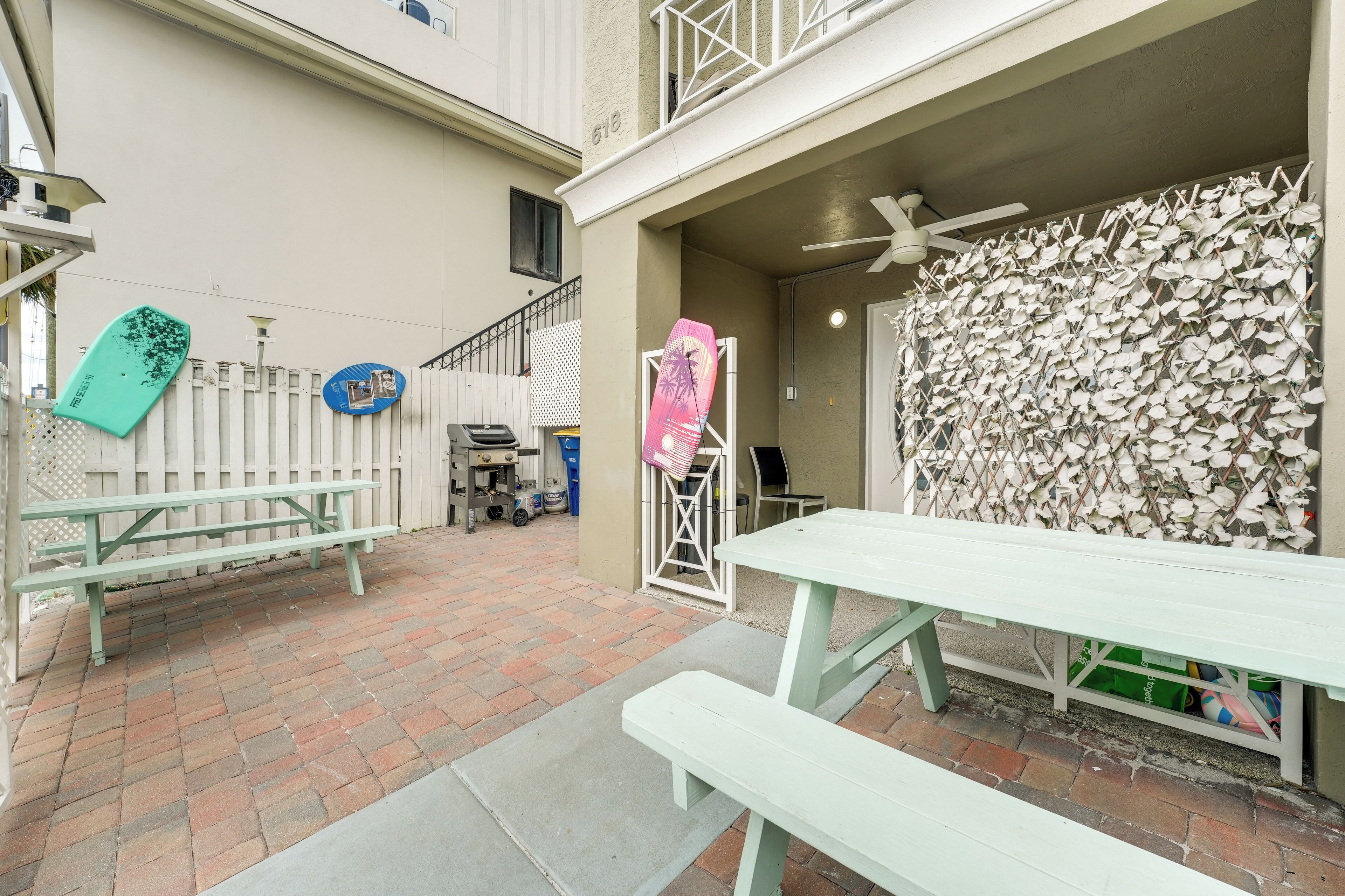 A patio area with picnic tables and a decorative wall.