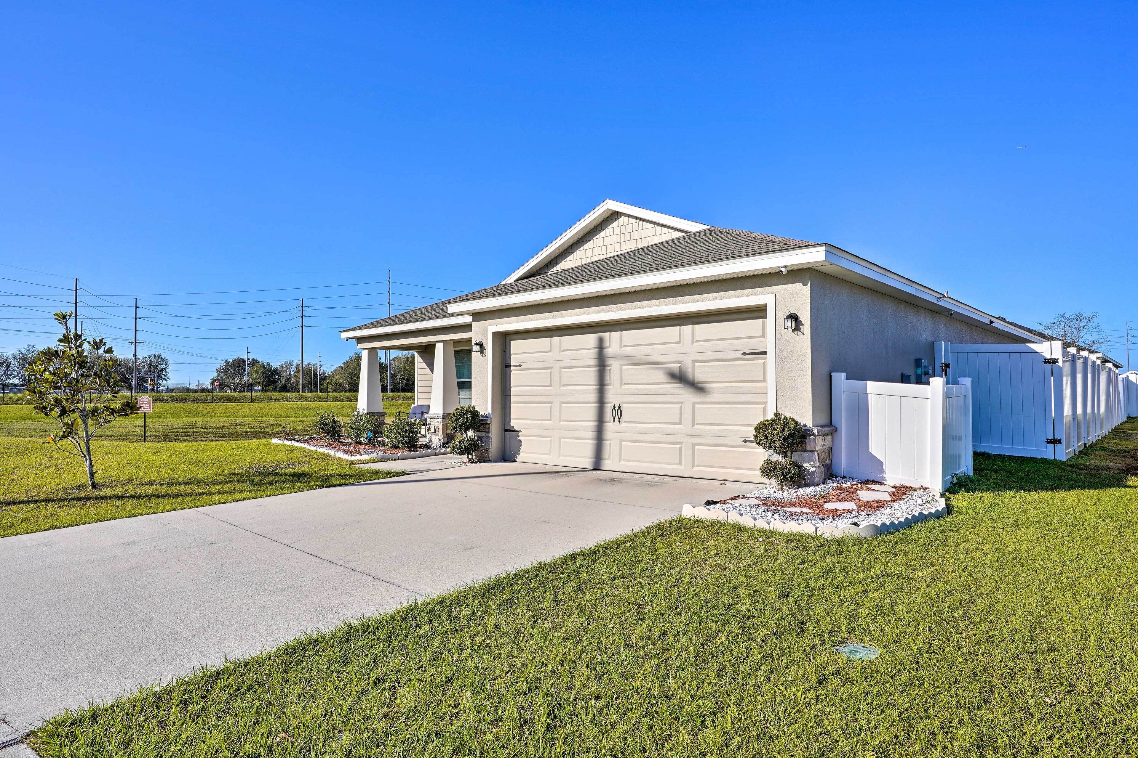 A single-story house with a garage, a covered porch, and a well-maintained lawn.