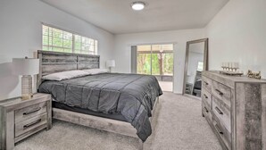 A bedroom with a bed, a dresser, a nightstand, and a window. - Family-friendly Ocala Retreat: 18 Mi to Dtwn! (Ocala)