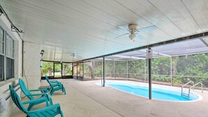 A covered outdoor area with a pool, lounge chairs, and a ceiling fan. - Family-friendly Ocala Retreat: 18 Mi to Dtwn! (Ocala)