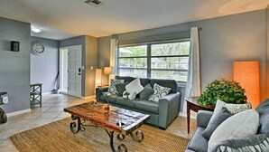 A living room with a grey sofa, a wooden coffee table, and a potted plant. - Florida Home 3 Mi to Siesta Key, Walk to Gulf Gate (Sarasota)