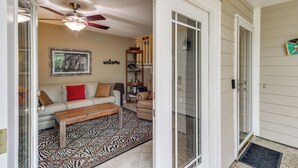 A living room with a sofa, coffee table, and a zebra-patterned rug. - 5 Mi to Pensacola Beach: Townhome w/ Yard! (Gulf Breeze)