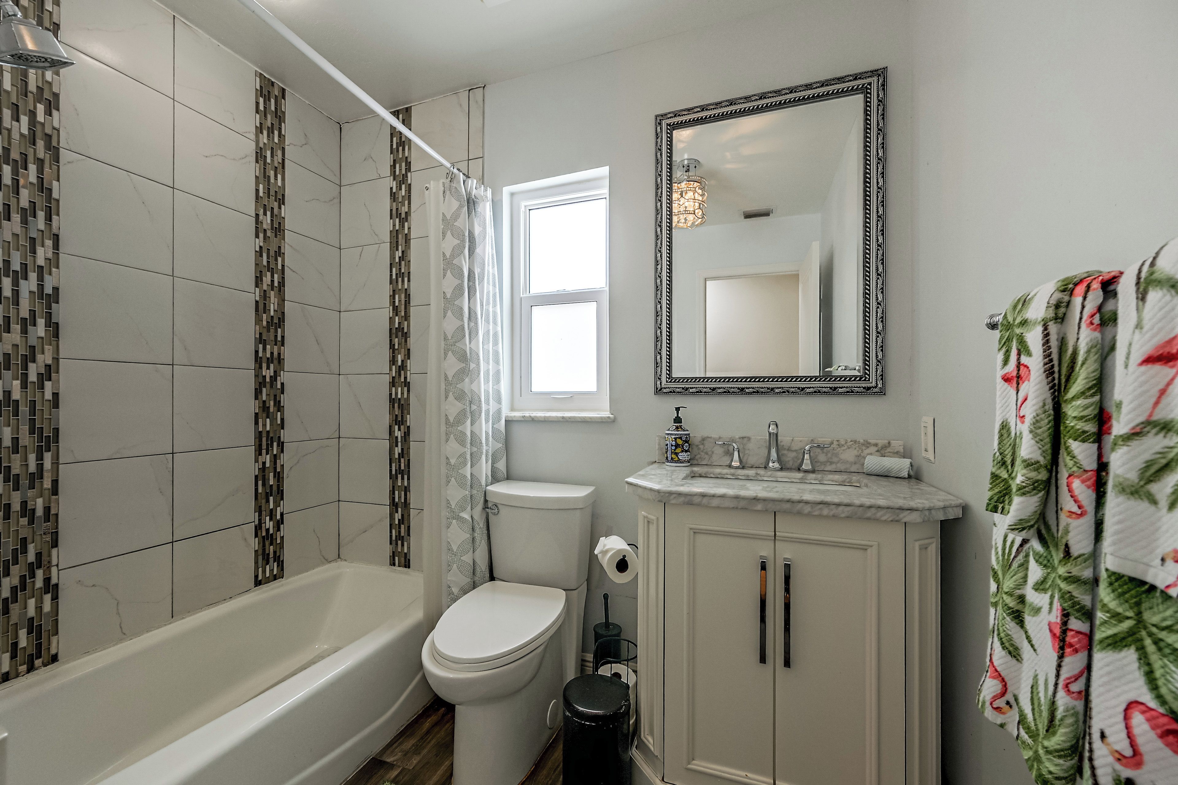 A bathroom with a bathtub, toilet, and sink.
