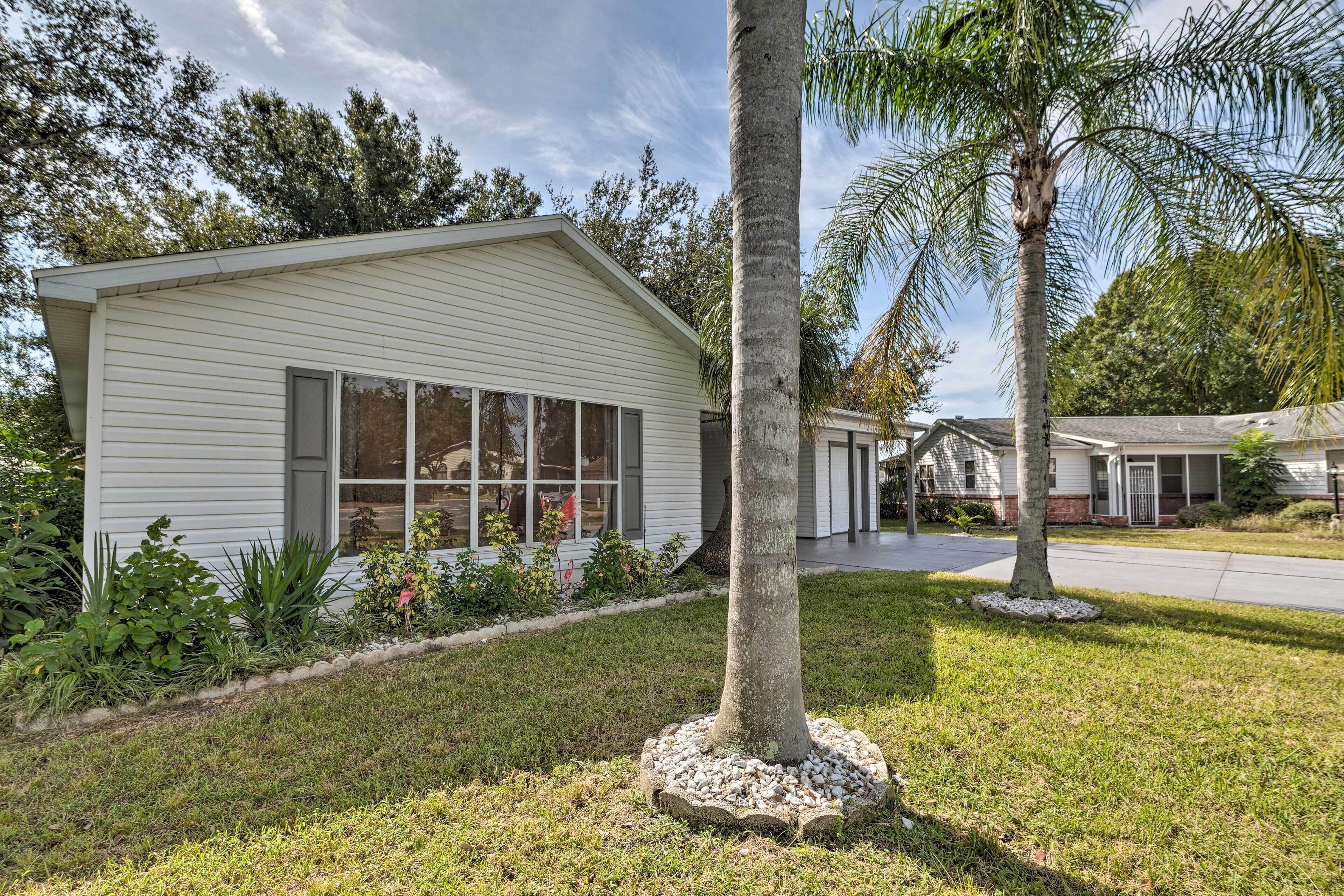 A single-story house with a sloped roof, large windows, and a front porch.