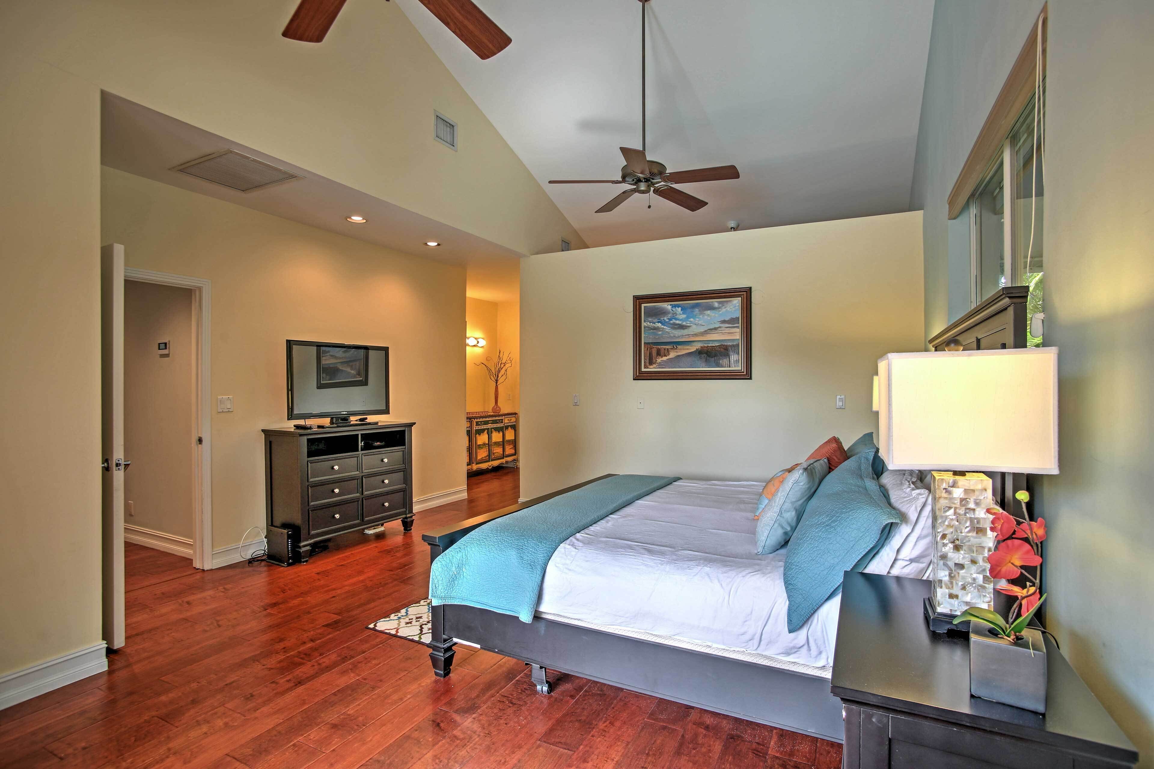 A bedroom with a bed, dresser, and nightstand.