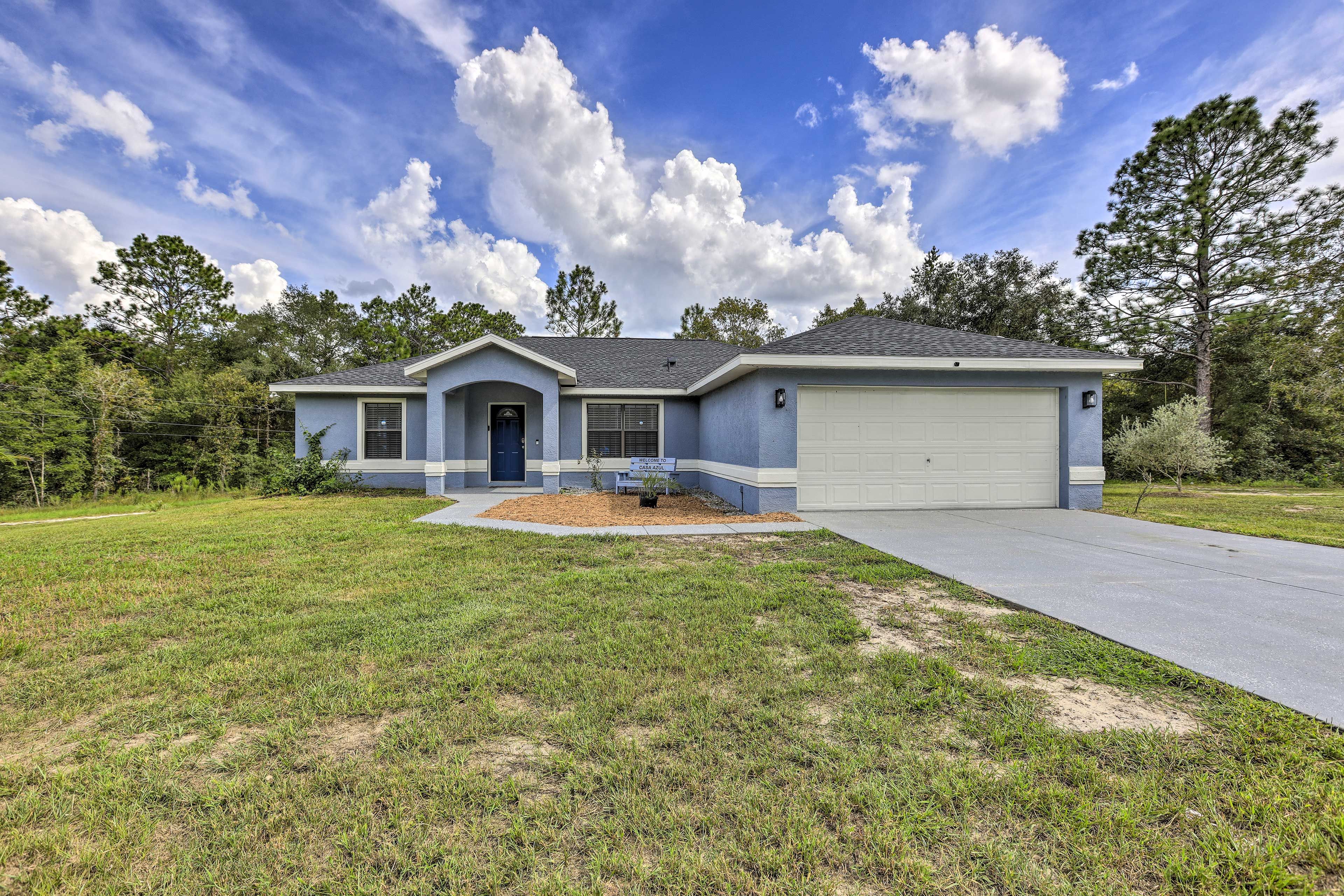 A single-story house with a garage, a front yard, and a driveway.