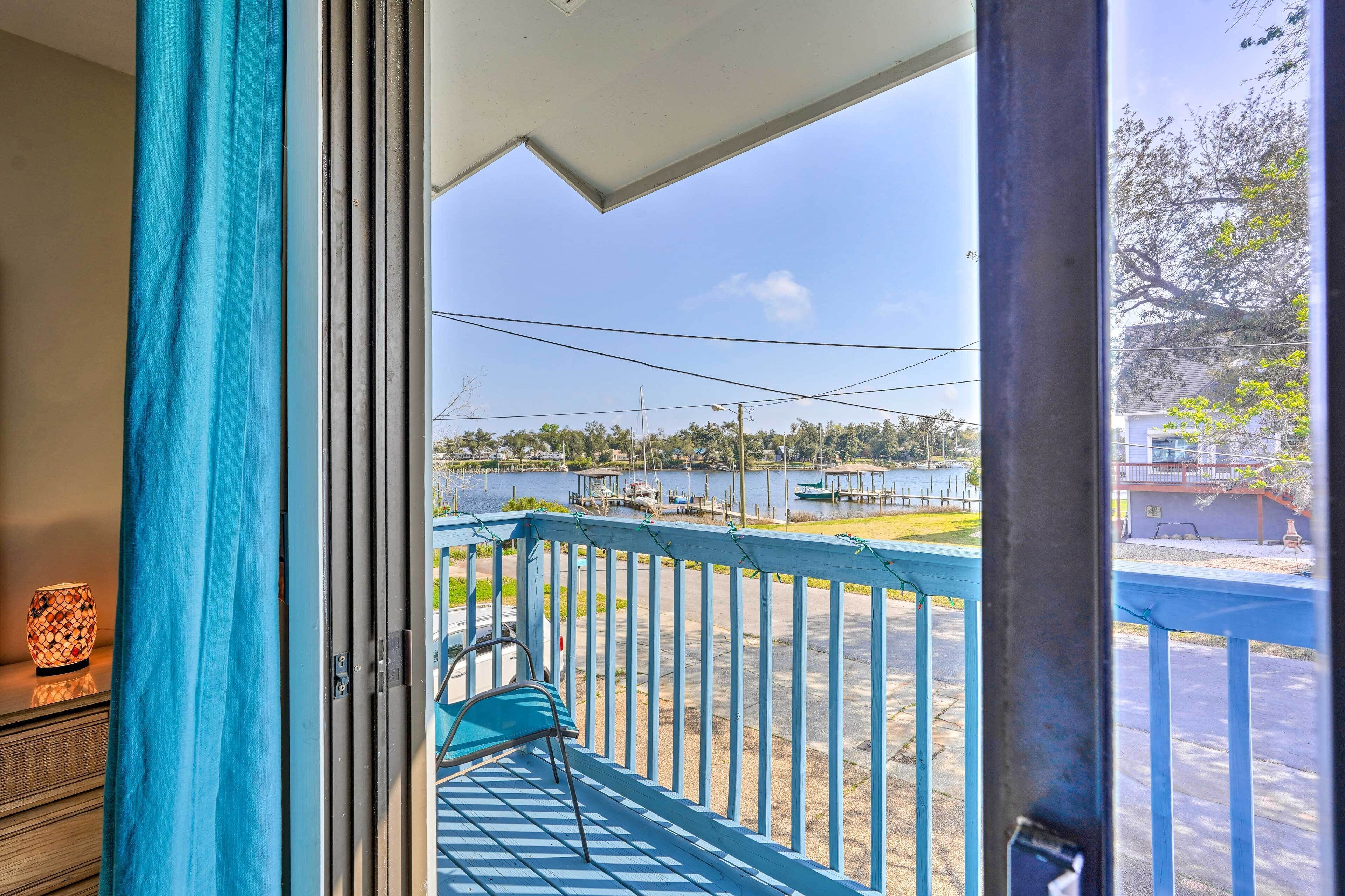 A balcony with a view of a marina and a lake.