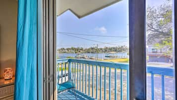 A balcony with a view of a marina and a lake.