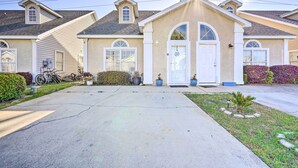 A residential house with a front porch, a garage, and a driveway.