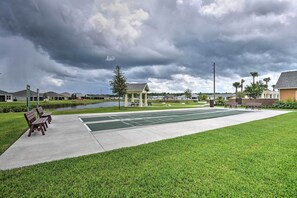 A park with a basketball court, benches, and a gazebo.
