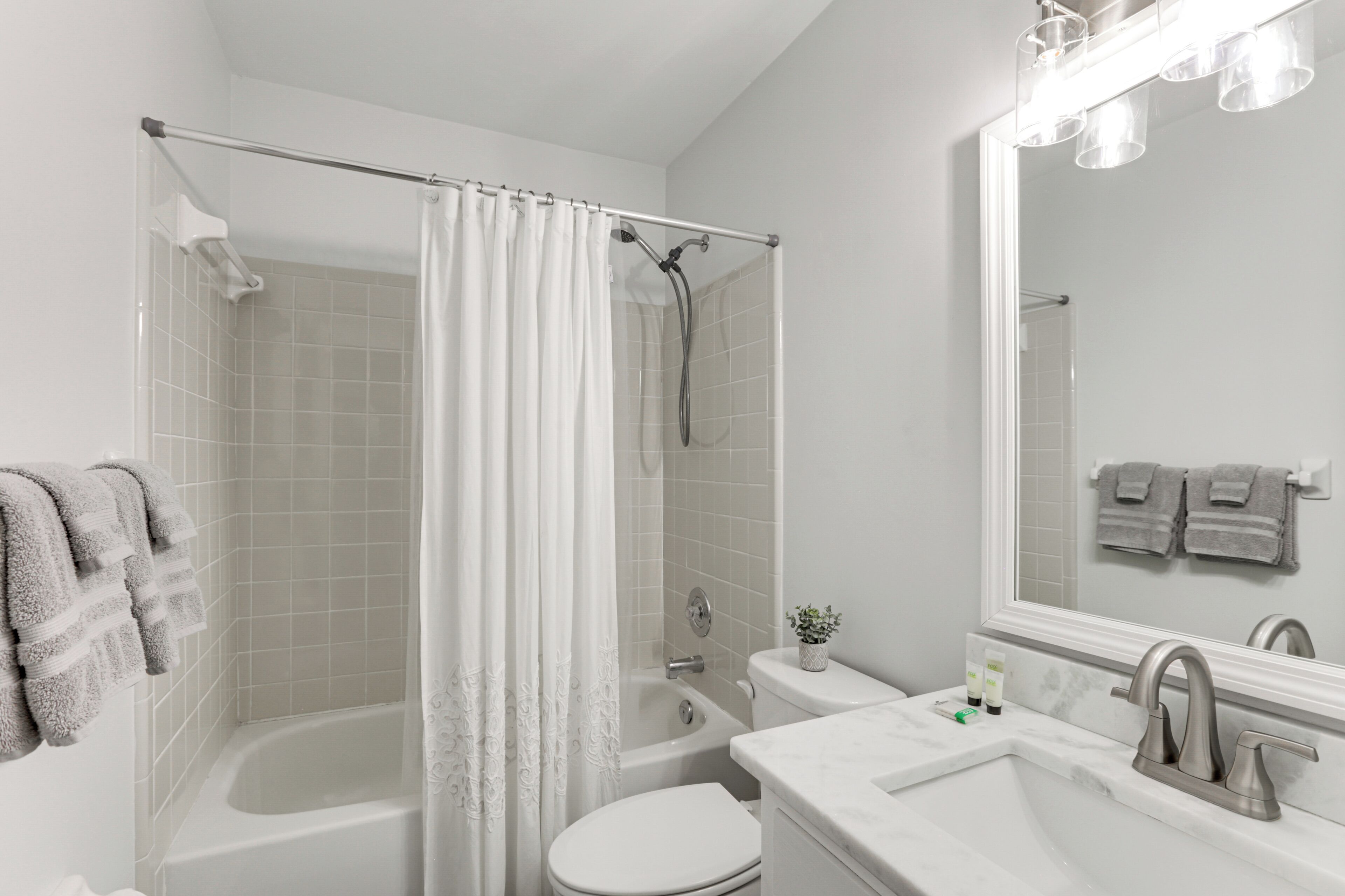 A bathroom with a bathtub, toilet, and sink, all in white.