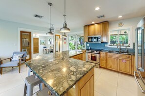 A modern kitchen with granite countertops, stainless steel appliances, and wooden cabinets. - Oakland Park Vacation Rental w/ Private Pool! (Oakland Park)