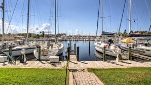 A marina with multiple sailboats docked at wooden piers. - Resort-style Condo w/ Pool: 19 Miles to Fort Myers (Punta Gorda)