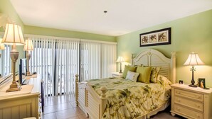 A bedroom with a bed, bedside tables, lamps, a window with blinds, and a framed picture on the wall. - Resort-style Condo w/ Pool: 19 Miles to Fort Myers (Punta Gorda)